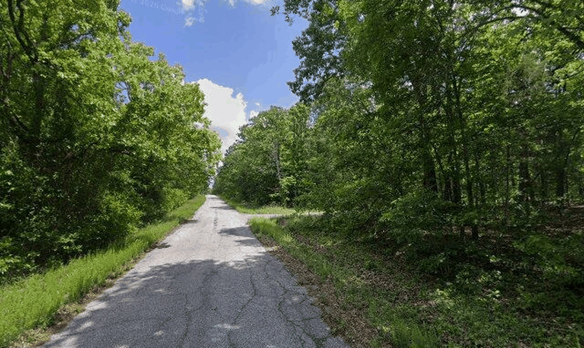 Street-level photo of the paved road through the Spring Addition subdivision where Lot 30 sits